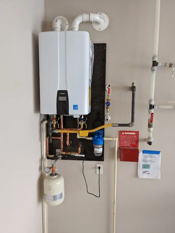 Professional plumber installing copper piping in a Hicksville home